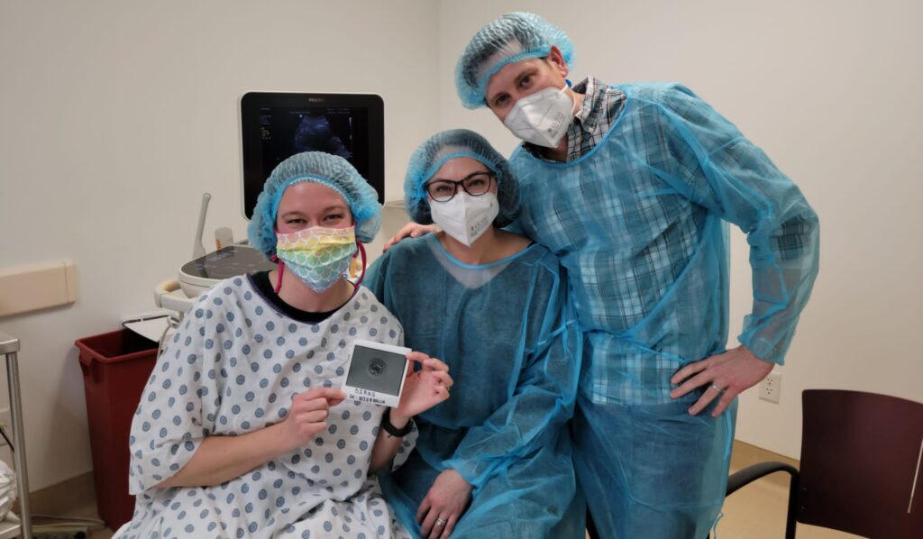 Image of surrogate and intended parents at fertility clinic for embryo transfer