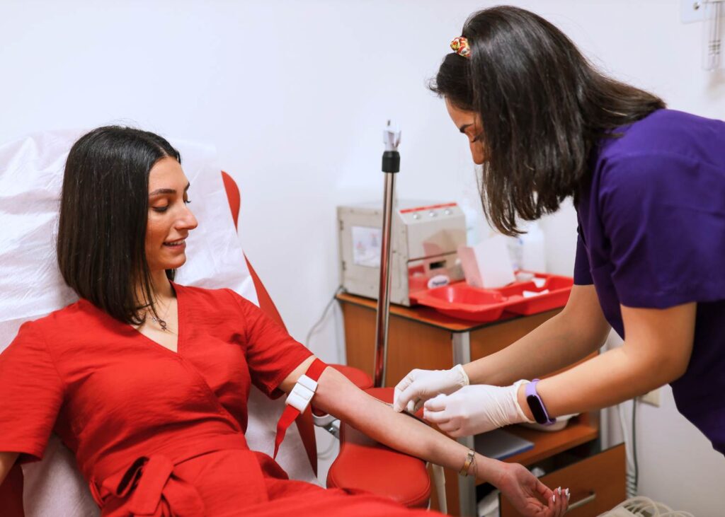 Image of surrogate getting blood drawn during medical screening