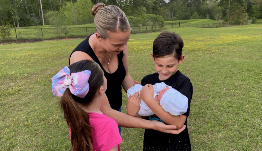 surrogate mother family holding baby